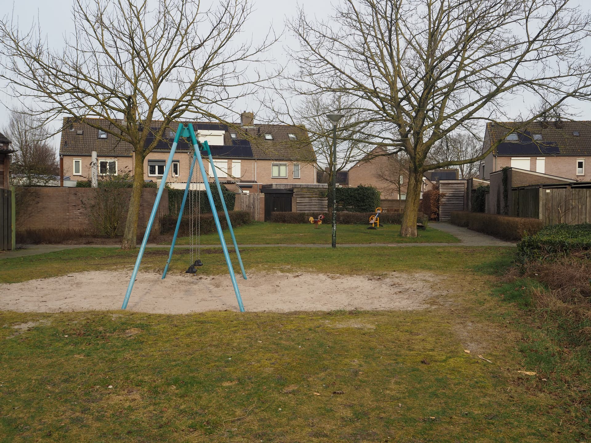Enlarge image: on the left side a swing with further back a teeter-totter and teeter-totter